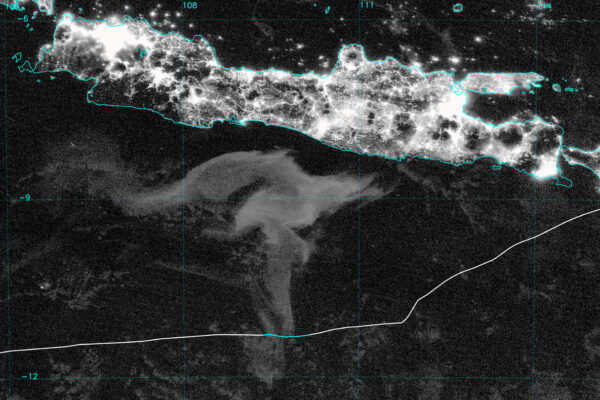 This satellite image shows a pale expanse of sea just below the island of Java in the Indian Ocean. A white line traversiing the image is the track of a yacht that sailed through this "milky sea." The track turns blue where the yacht traveled through the giant patch of bioluminescence.