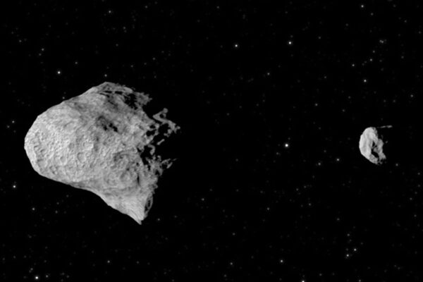 A photo of a large asteroid next to a small asteroid