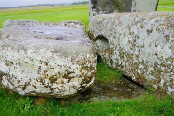 Two large stones sit in a grassy field