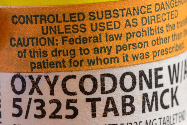 A close up view of a pill bottle of Oxycodone, with an orange caution label at the top. Taking semaglutide may help people avoid overdosing on this and other opioids, a new study suggests.