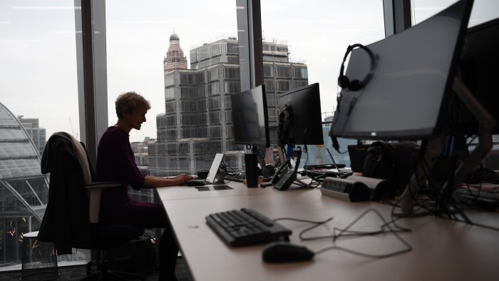 A member of staff poses for a photograph at a workspace in the National Cyber Security Centre on February 14, 2017 in London