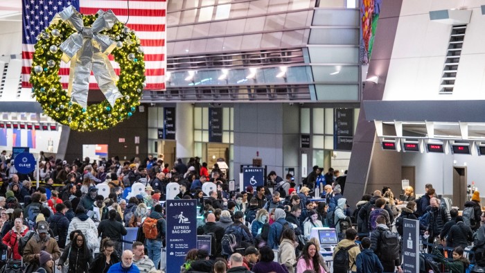 People move through departures at Boston’s Logan Airport